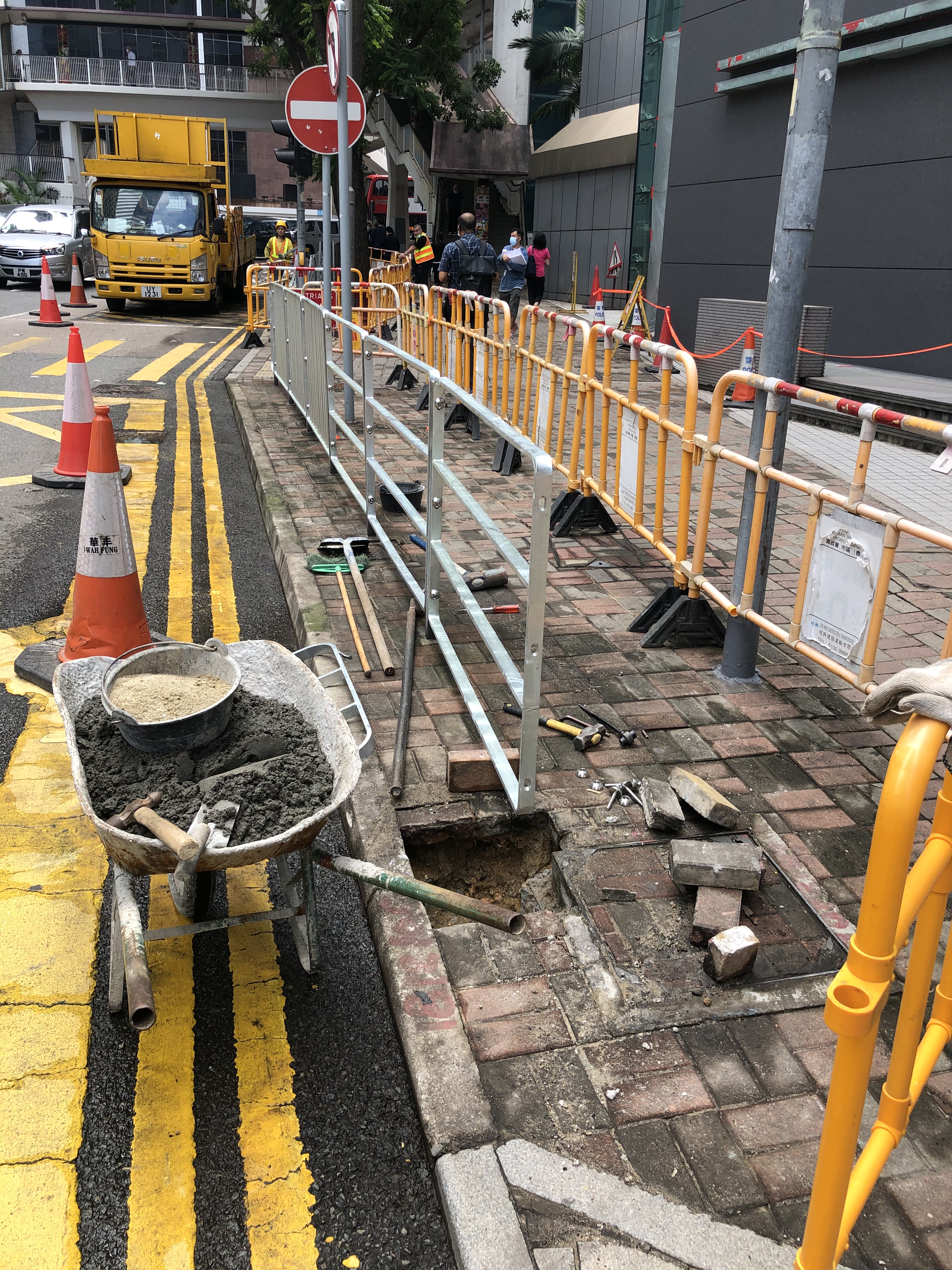 香港國安法生效以來，暴徒受到震懾，黑暴行為漸漸降溫。昨晚，位於灣仔軍器廠街的警察總部外水馬被撤走。今日上午，記者到達現場，發現警總外已看不到水馬，惟擺了一年的水馬，令地上留下痕跡，工人正在現場施工。據悉，本港多個政府部門及中央駐港機構，在去年反修例示威時，由7月開始架設大型水馬，而除了警察總部，多間警署外亦都放置有水馬。（大公報突發組攝）