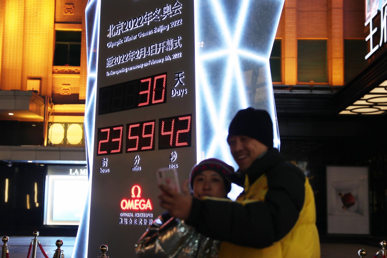 1月4日，人們在位於北京王府井大街的北京2022年冬奧會倒計時牌前自拍。當日，北京2022年冬奧會迎來開幕倒計時一個月（新華社）。
