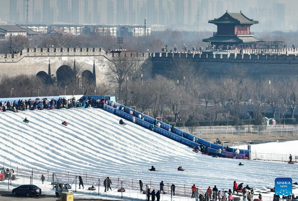 This aerial drone photo taken on Dec. 28, 2025 shows people playing in an ice-and-snow theme park in Zhengding County of north China's Hebei Province. (Photo by Zhang Xiaofeng/Xinhua)