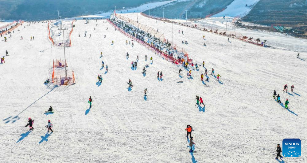 This aerial drone photo taken on Dec. 28, 2025 shows people skiing at a ski resort in Yutian County of north China's Hebei Province. (Photo by Liu Mancang/Xinhua)