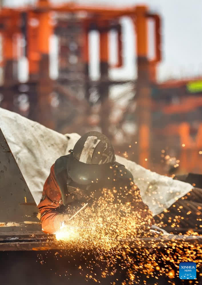 A construction worker is seen at an offshore oil and gas platform at the Binhai New Area, in north China's Tianjin on Jan. 29, 2026. Enterprises across the country are going full steam ahead in production at the end of January, striving for a strong start in the first month of a new year. (Photo by Du Penghui/Xinhua)