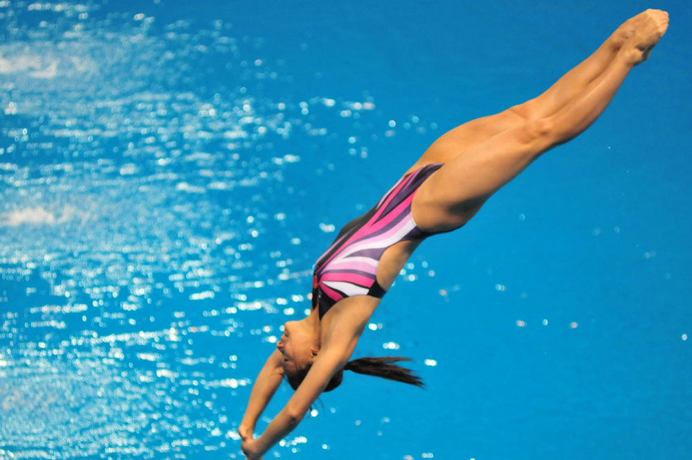 　　圖：何姿談笑用兵地在女子3米板折桂 本報攝