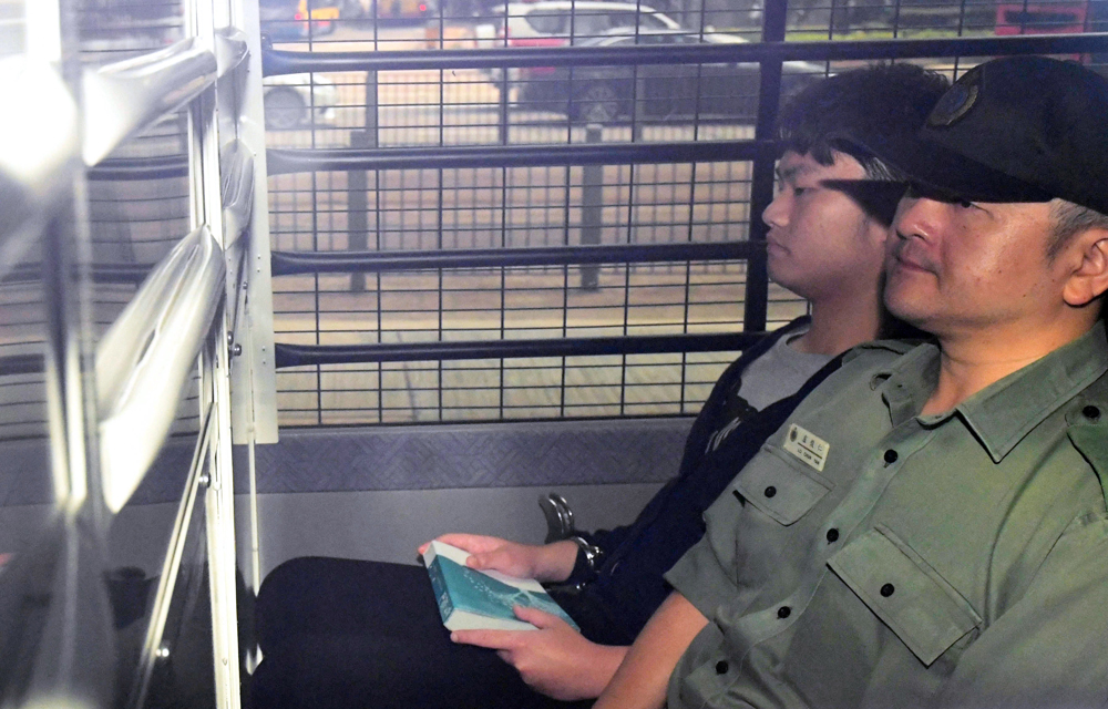 　　圖：在台灣殺害女友疑兇陳同佳昨僅以洗黑錢罪判囚29個月。圖為陳同佳戴手銬坐囚車被押解出庭途中