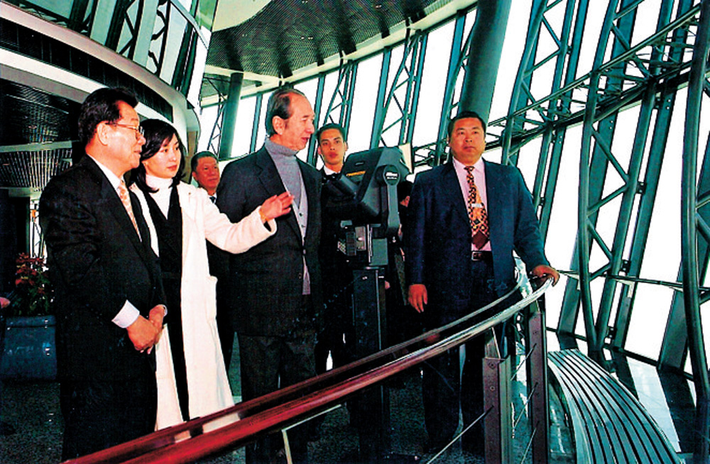 　　圖：2003年，信德集團主席何鴻燊及董事總經理何超瓊陪同時任全國政協主席李瑞環（左）參觀旅遊塔