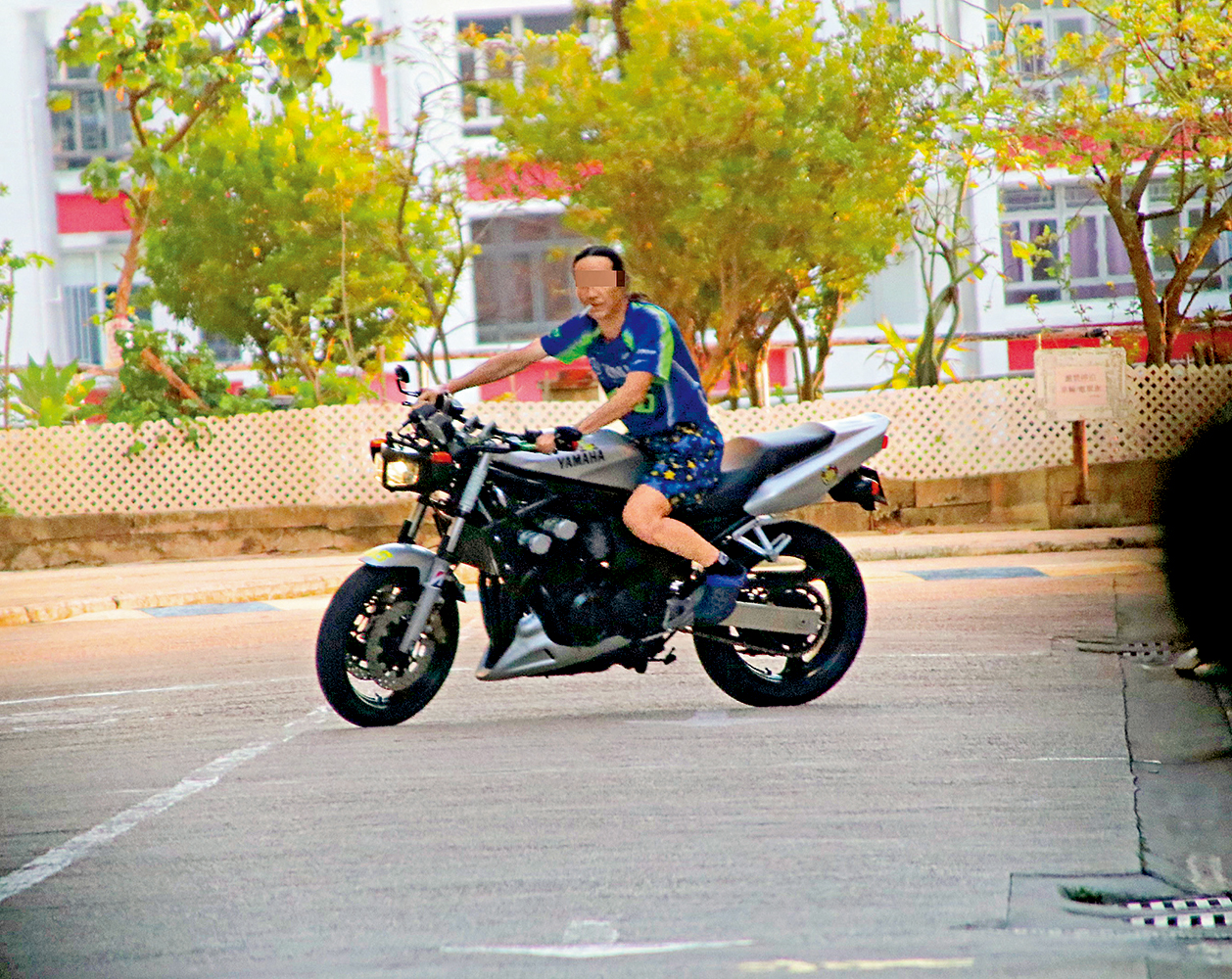 　　圖：「倡少」在康利苑內邊食煙邊不戴頭盔駕駛電單車。