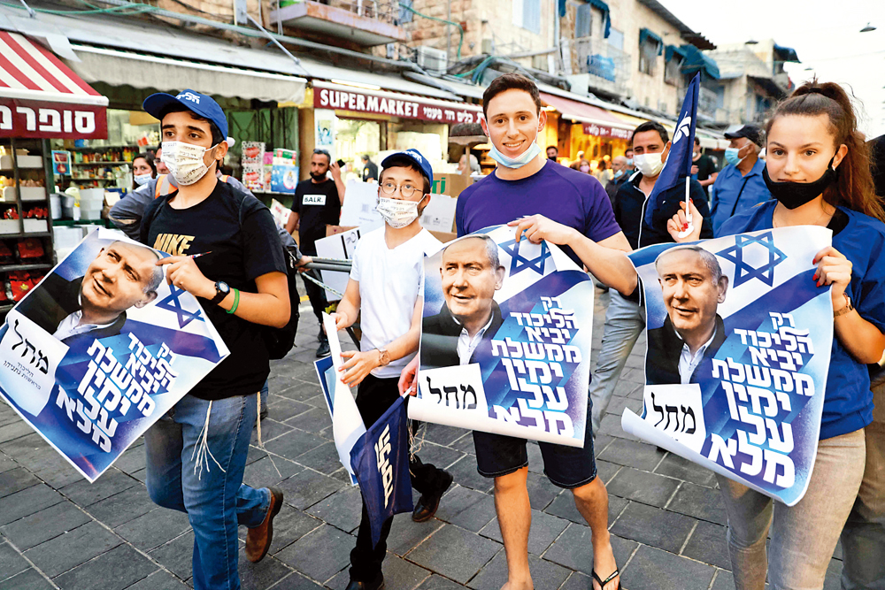 　　圖：利庫德集團支持者21日在耶路撒冷遊行，為內氏拉票。\法新社