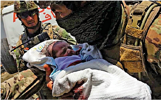 　　圖：2020年5月喀布爾一間婦幼醫院遭遇恐襲，政府軍士兵救出一名新生兒。\法新社