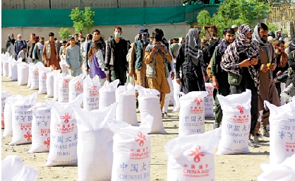 　　圖：4月23日，阿富汗民眾在喀布爾領取中國援助的糧食。\新華社