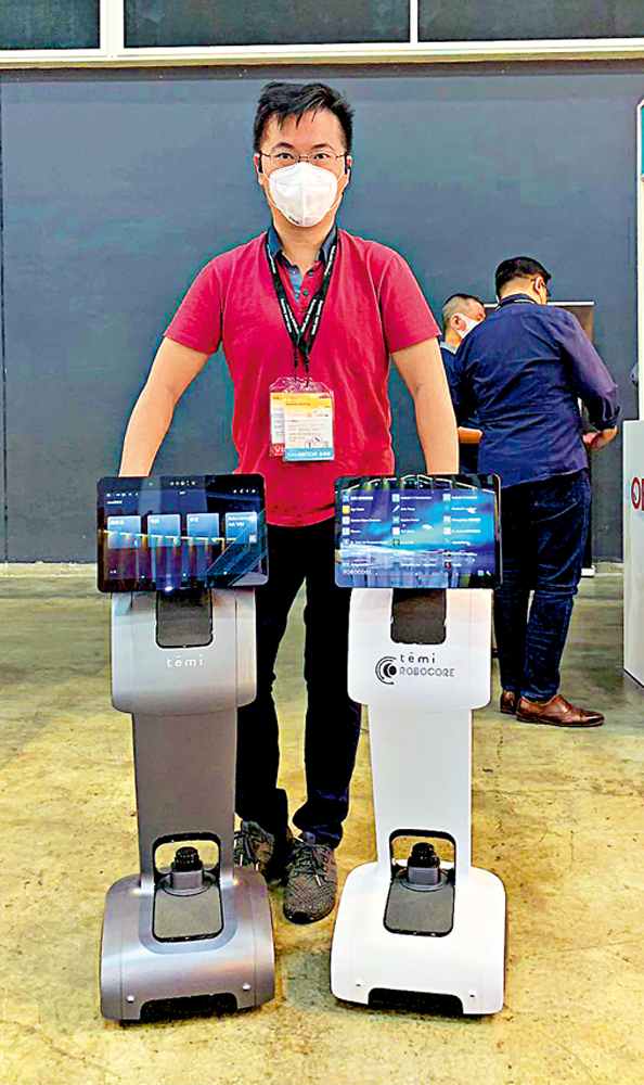 　　圖：林朗熙和Temi機器人。