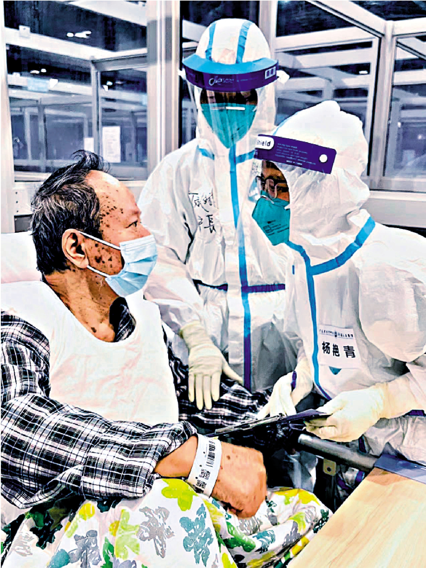 　　圖：3月28日，內地援港醫療隊隊員在亞博館新冠治療中心詢問患者病史。/新華社