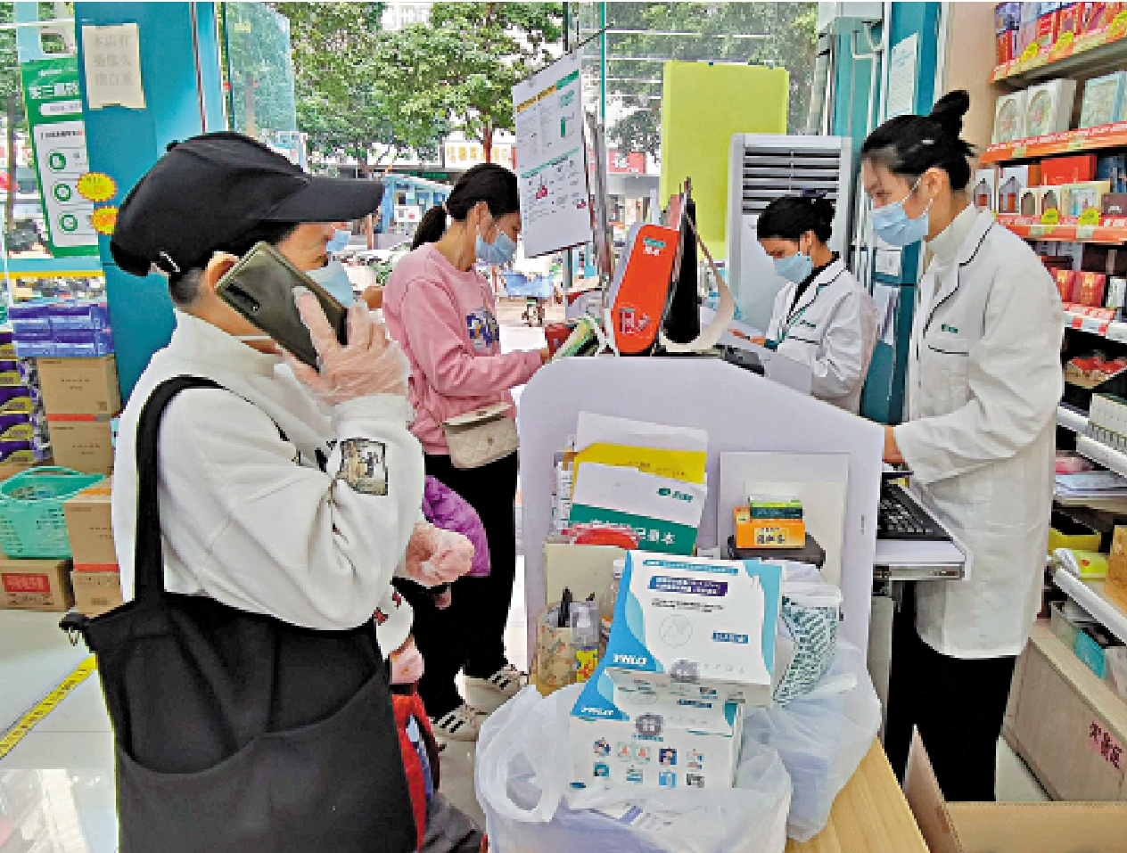 　　圖：在深圳藥房，市民打電話通知朋友來購買抗原檢測試劑盒。\大公報記者郭若溪攝