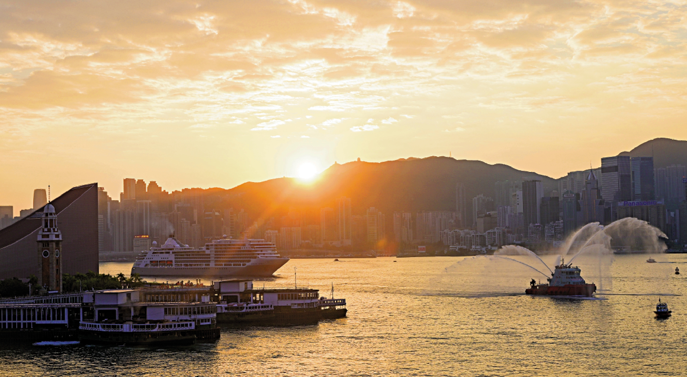 　　圖：「銀靈號」進入維港，消防船在海運碼頭外噴水歡迎。 中通社