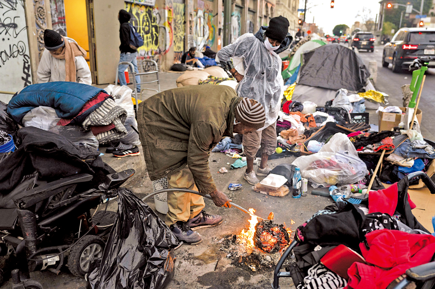 　　圖：美國洛杉磯貧民窟流浪漢14日點火取暖。\美聯社