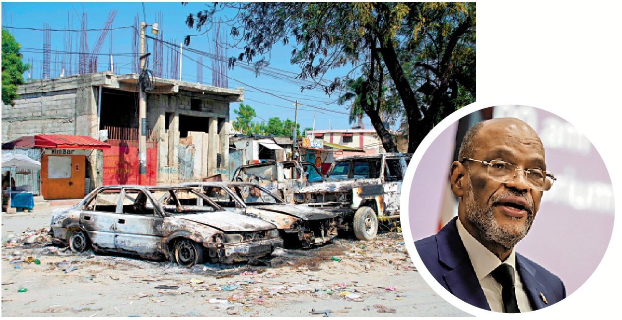 　　圖：海地首都太子港街頭的汽車被縱火，小圖為海地總理亨利。\法新社