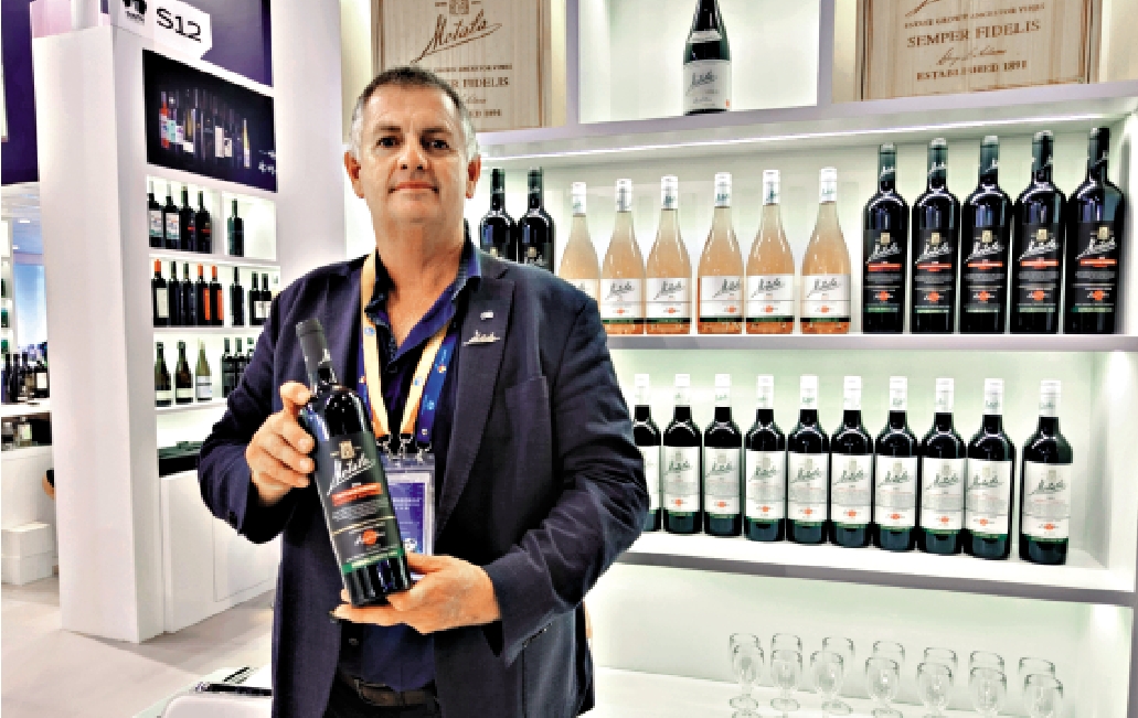 　　圖：參加第六屆進博會的澳洲葡萄酒商展示自己的產品。