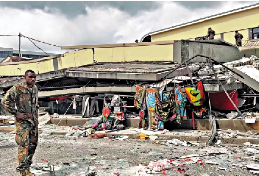 　　圖：瓦努阿圖地震發生後，一名安全人員正在檢查維拉港倒塌的建築物。\法新社