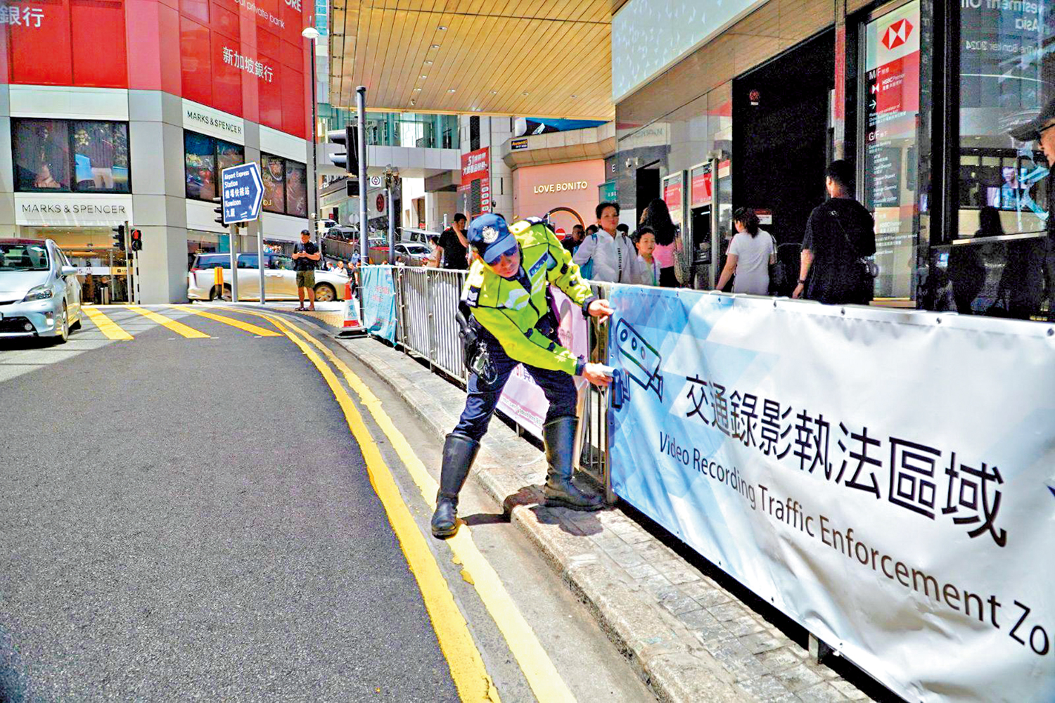 圖:警員昨日在上述的地點掛設橫幅提示,並派發宣傳單張。
