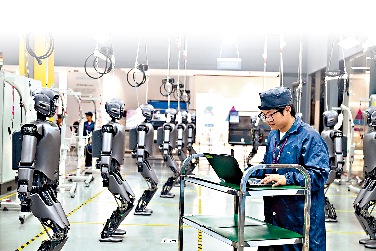 　　圖：AI作為當下炙手可熱的全新風口，憑藉強勁發展潛力，吸引大量投資者爭相布局。圖為工人正在檢查工業版人形機器人。 新華社