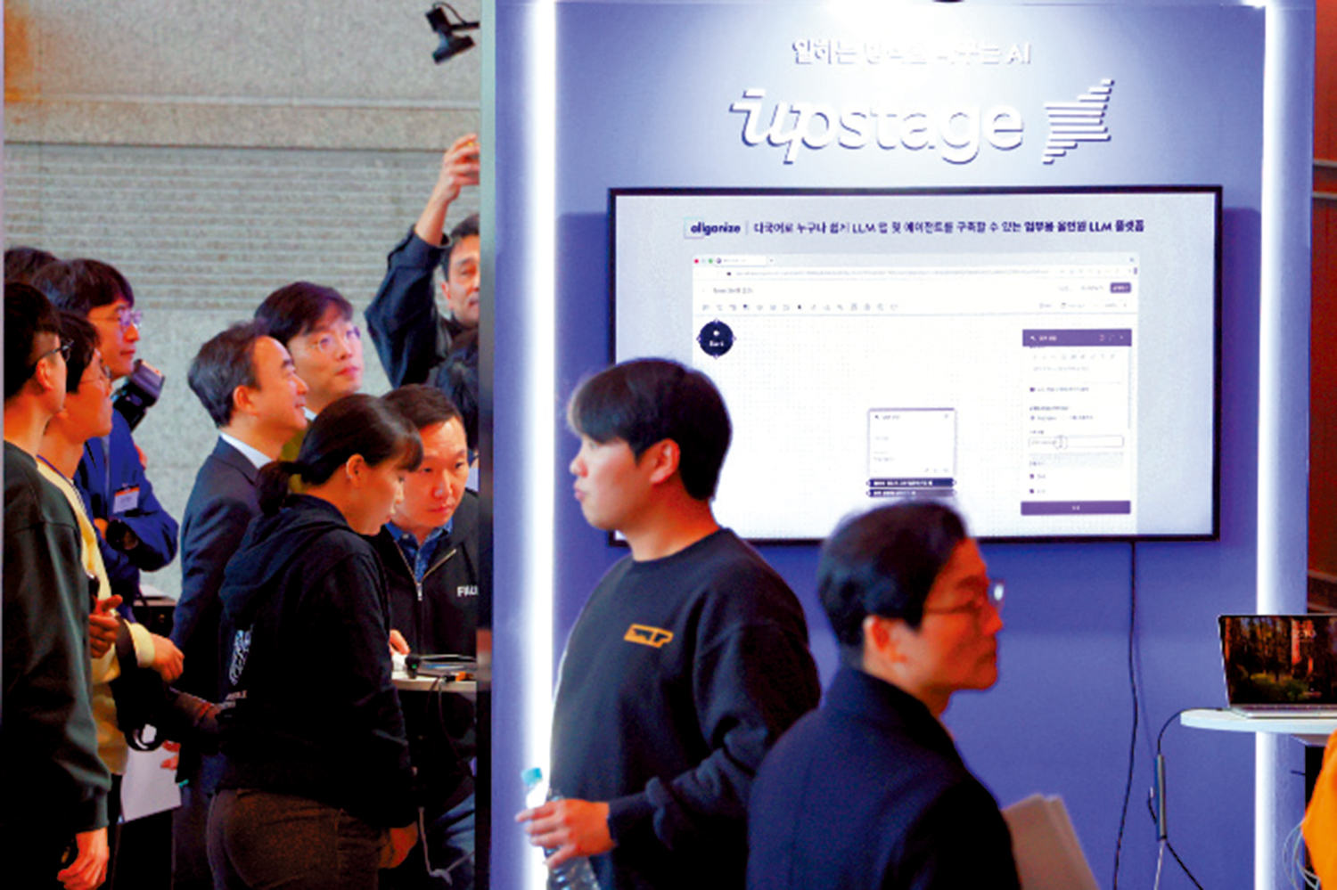 　　圖：韓國本土AI模型大賽去年12月在首爾韓國貿易中心舉行首次發布會，參觀者正在參觀Upstage展台。\韓聯社