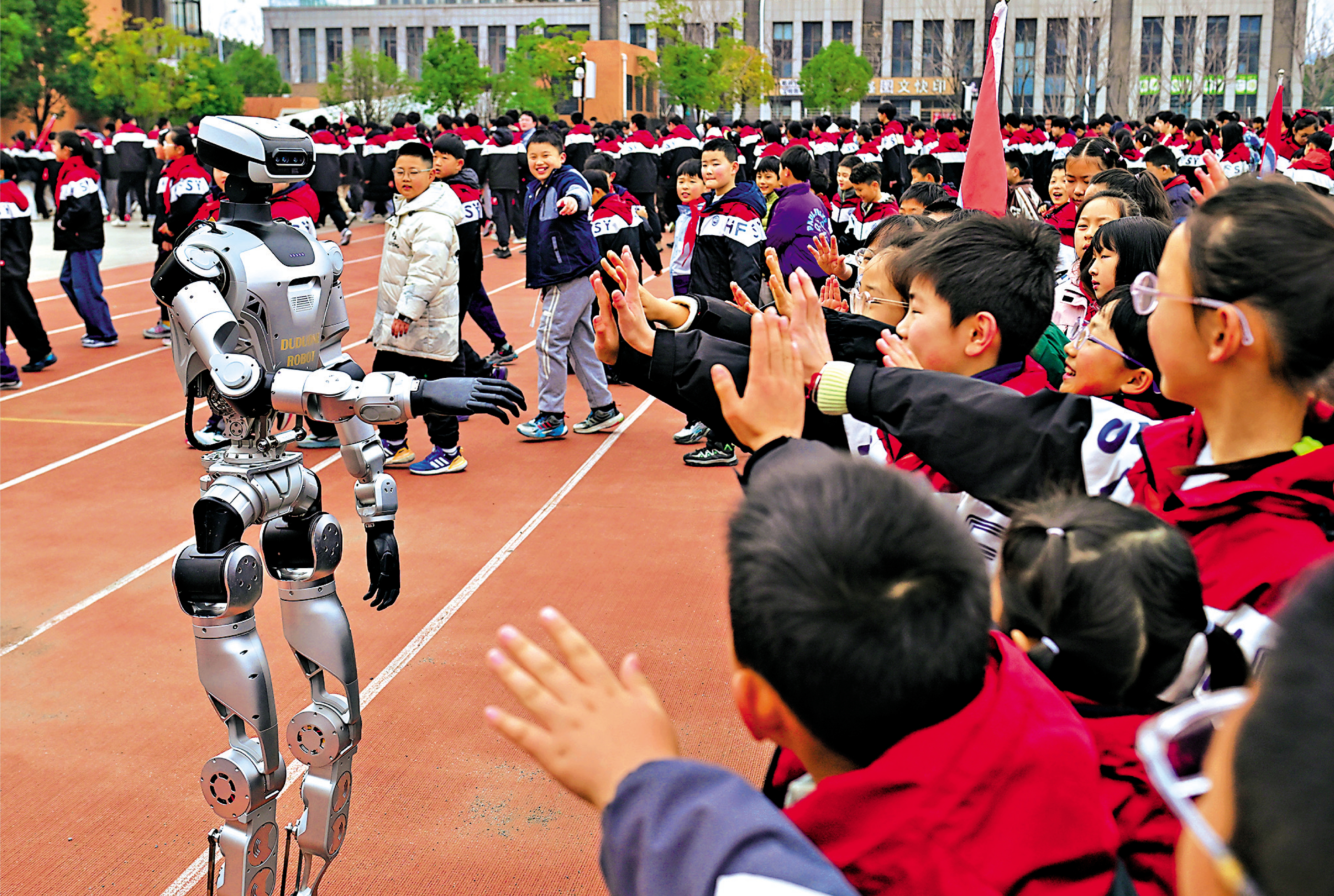 　　圖：政府工作報告提出，要加快高水平科技自立自強。圖為5日，機器人在安徽合肥一家學校與學生們互動。\中新社
