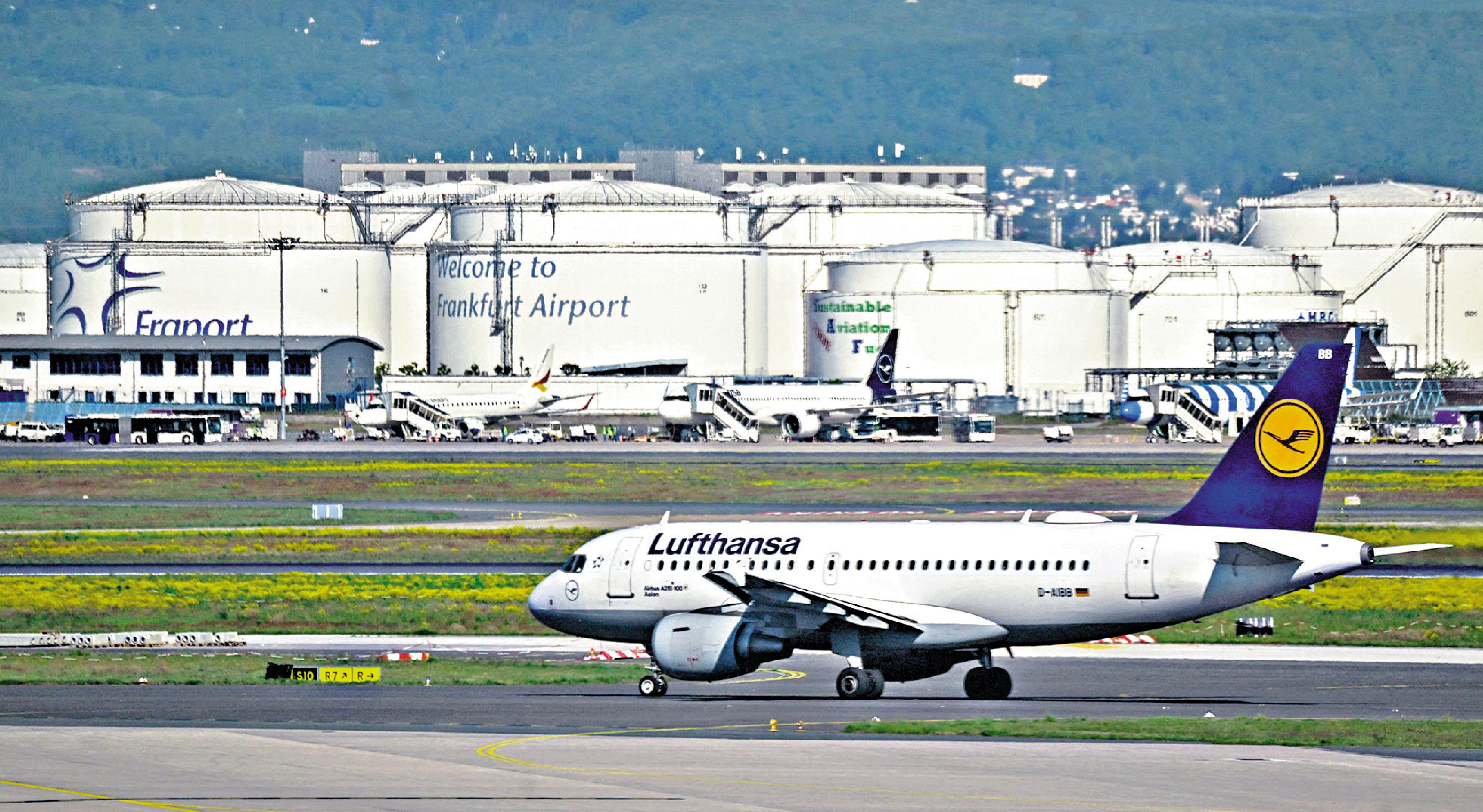 　　圖：一架漢莎航空客機在德國法蘭克福機場跑道上行駛，附近可見航空燃油儲油槽。\路透社