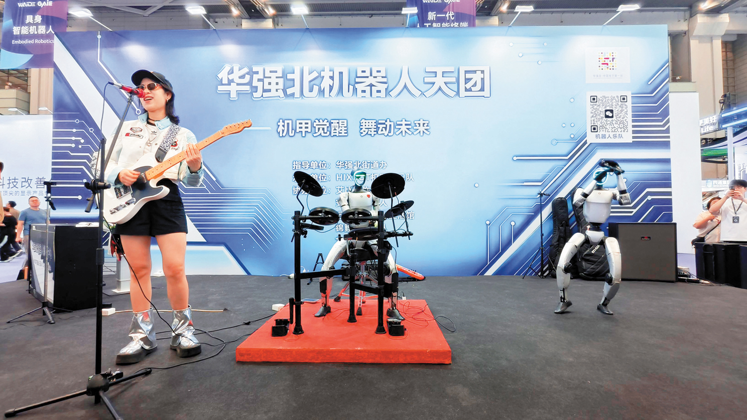 　　圖：在展會現場，華強北的機器人天團與真人歌手共同演繹歌曲《海闊天空》，架子鼓機器人、結他機器人、舞蹈機器人配合默契。\大公報記者毛麗娟攝