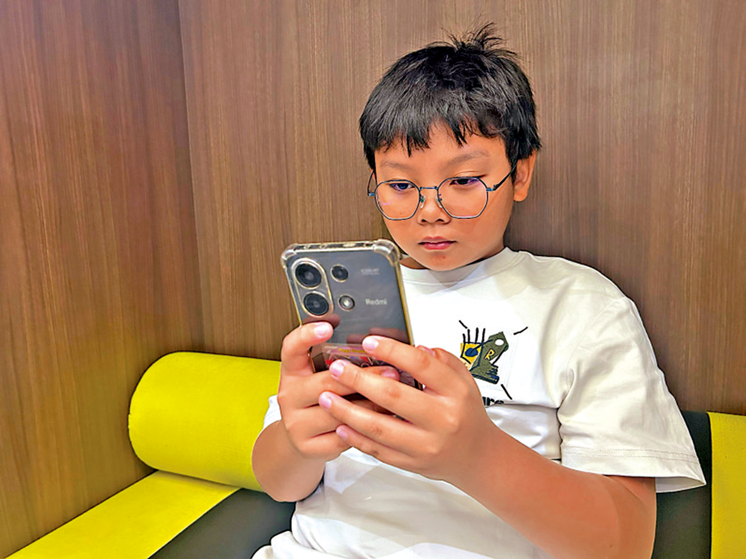 　　圖：馬來西亞禁止未滿16歲兒童註冊社媒賬號。圖為11歲的馬來西亞學生使用智能手機。\美聯社