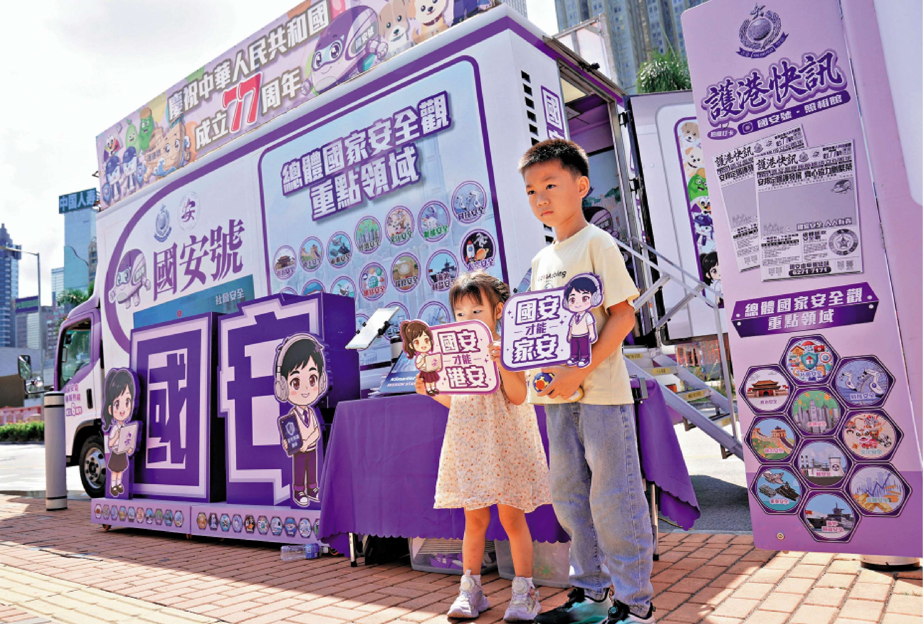 　　圖：小朋友在NSpeed國安號宣傳車的「NSmarties童心護港AI互動平台」體驗後打卡留念。\警方圖片