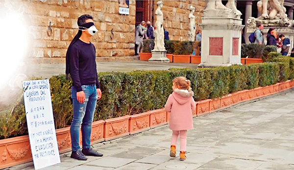 ■因肺炎疫情，海外中國公民和華人屢屢受到歧視，一名生活在意大利佛羅倫斯的華人男子於是走上街頭，戴上口罩，蒙住眼睛，在身邊放下「我不是病毒」標語，希望透過與他人擁抱，消除外界對華人的歧視，多名途人送上擁抱，場面令人動容。