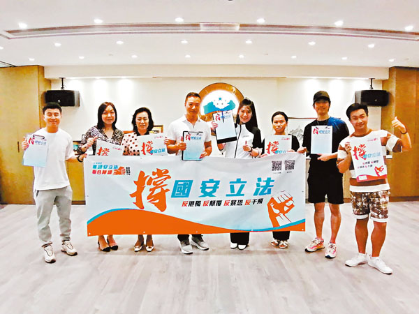 ■ 海口會執行會長陳李妮和常務副會長朱鼎耀昨日帶領會員簽名撐「港區國安法」。