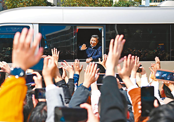 ● 習近平在福州閩江學院考察時，向師生們揮手致意。 新華社