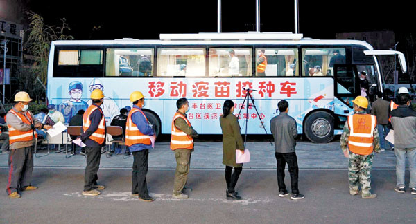 ● 3月29日晚上7時30分，北京豐台火車站工地的工人們在移動新冠疫苗接種車前有序排起了長隊打疫苗。 網上圖片