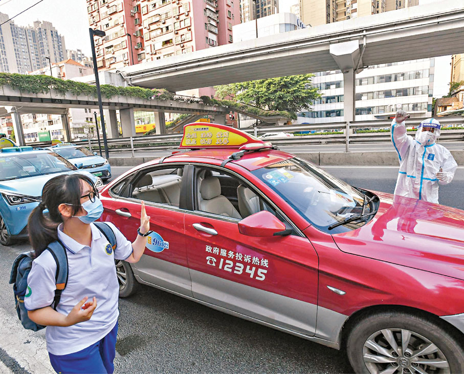 ●一名考生到達目的地後和專車司機說再見。 新華社
