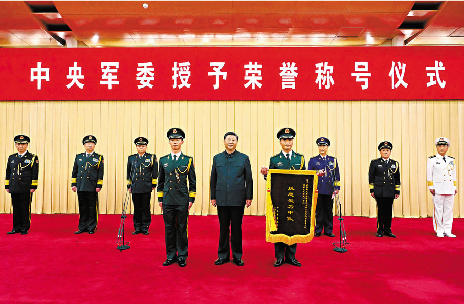 ●5日，中央軍委授予榮譽稱號儀式在北京隆重舉行。中央軍委主席習近平向獲得「反恐尖刀中隊」榮譽稱號的武警部隊新疆維吾爾自治區總隊某機動支隊特戰大隊特戰一中隊頒授獎旗，並同該中隊代表合影留念。     新華社