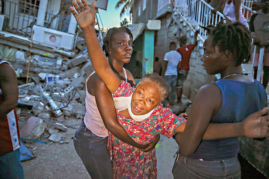 ● 婦人的7歲女兒在地震中喪命，她得悉消息後嚎哭。 美聯社