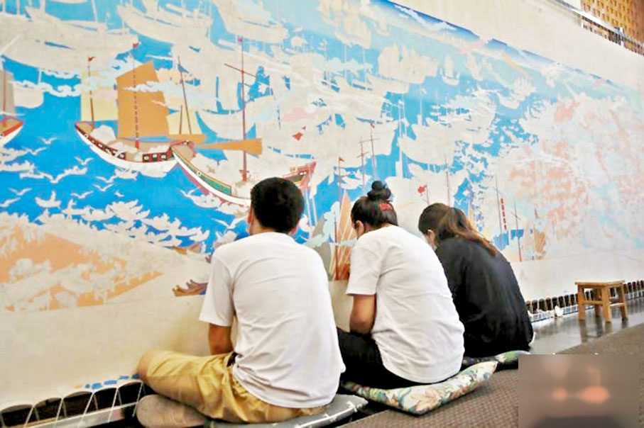 ●唐卡畫師正在進行「東方大港」主題畫卷的創作。