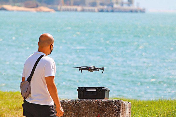 ●有警員在龍鼓灘岸上遙控航拍機搜索墮海失蹤女督察。 香港文匯報記者  攝