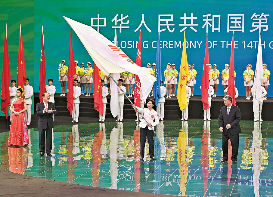 ●林鄭月娥在閉幕式會旗交接儀式上揮舞中華人民共和國運動會會旗。  新華社