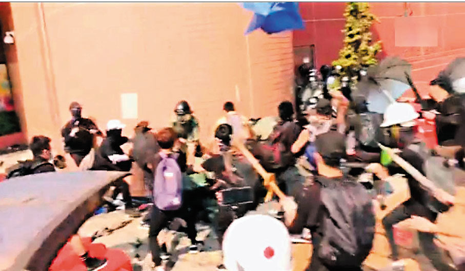 ●前年10月1日逾千黑暴在屯門大會堂外非法集結大肆破壞，一度有防暴警遭圍攻。 資料圖片