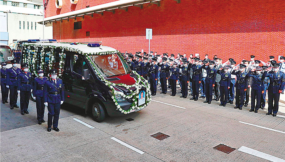 ●載着林婉儀靈柩的靈車離開殯儀館，警隊高層及同袍列隊致敬。 香港文匯報記者  攝