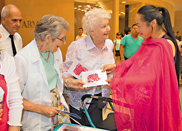 ●中國吉林文化周數年前在洛杉磯舉行，李寶鳳向美國觀眾展示剪紙作品。 資料圖片