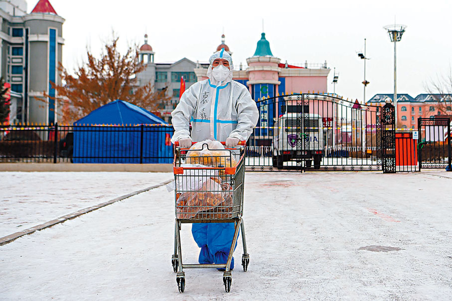 ● 11月29日，在滿洲里市東山街道辦事處怡園社區府欣小區A區，工作人員運送物資。 新華社