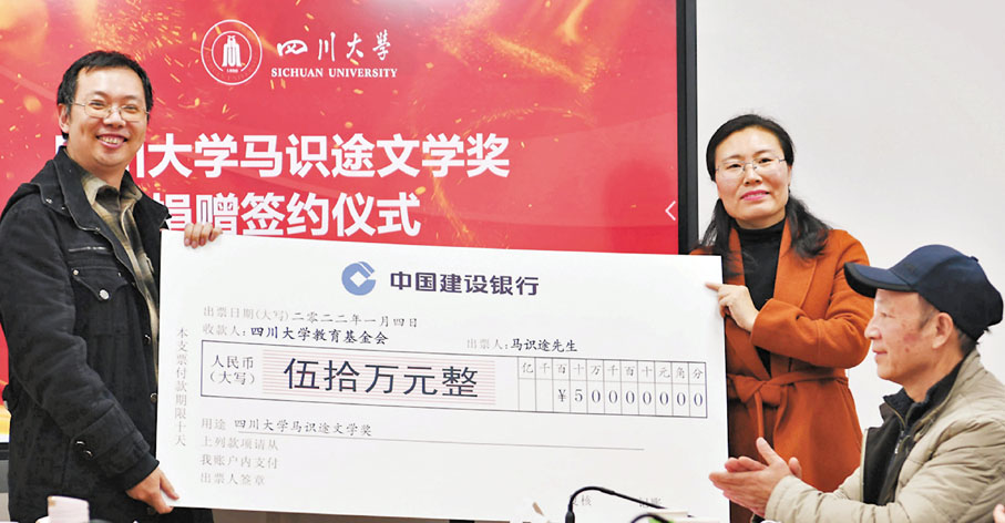◆捐贈儀式現場，馬識途外孫劉曉遠（左）遞送捐贈支票牌。 中新社