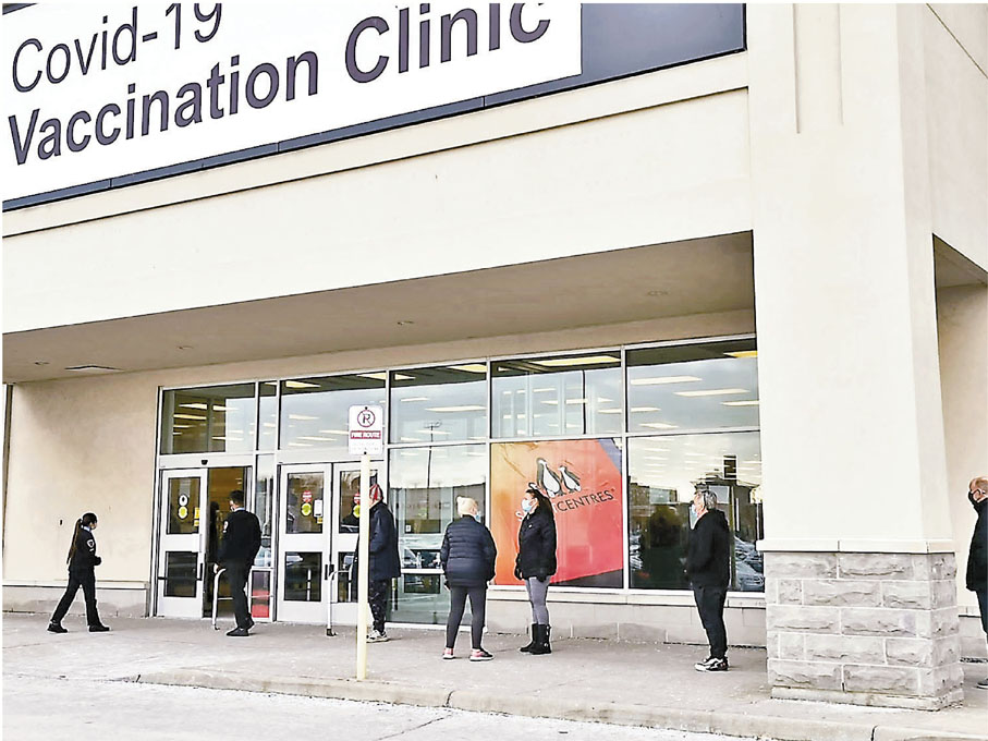 ◆ 多倫多不斷增設疫苗診所，市民等候時緊守社交距離規定。  成小智  攝