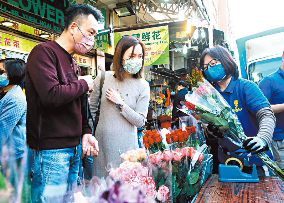 ◆情侶在佳節下選購花束，表達愛意。香港文匯報記者  攝