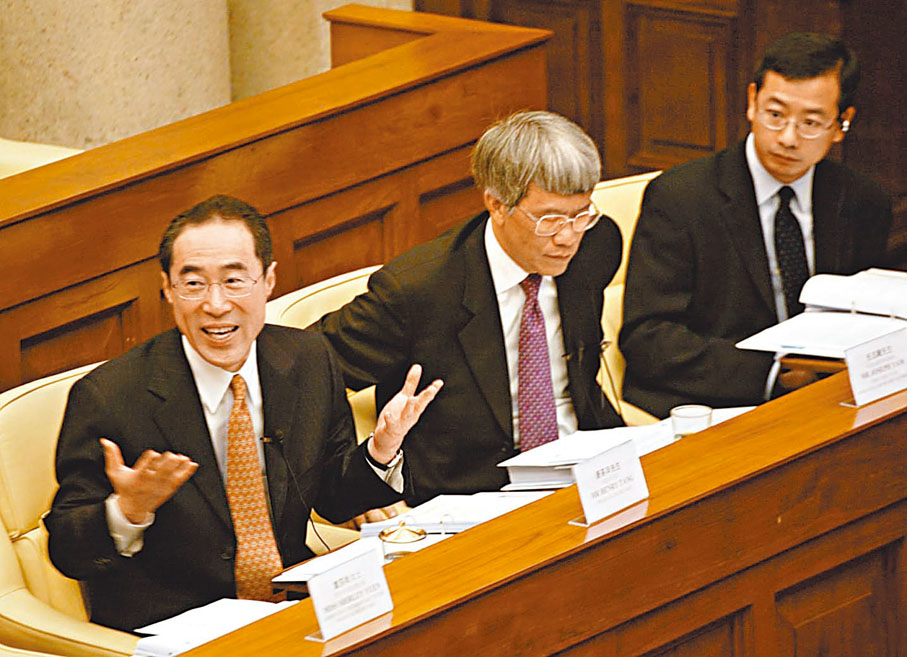 ◆余偉文(右)2004年作為金管局助理總裁出席立法會會議。左為時任財政司司長唐英年及金管局總裁任志剛（中）。 