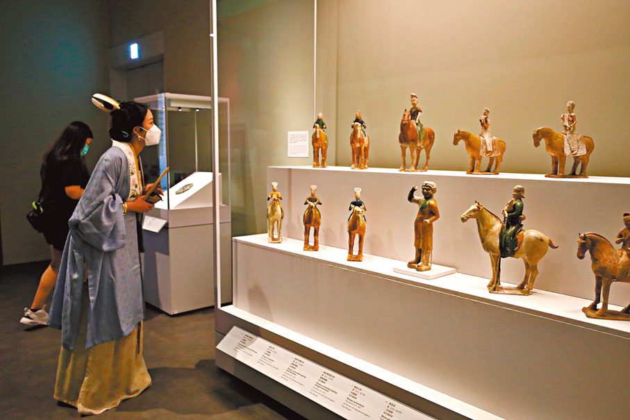 ◆ 市民古裝打扮欣賞展品。  香港文匯報記者  攝