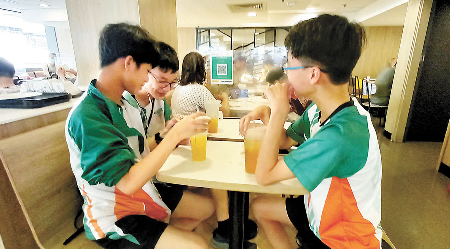 ◆有剛剛放學的中學生在麥當勞內飲嘢避暑。 香港文匯報記者 攝