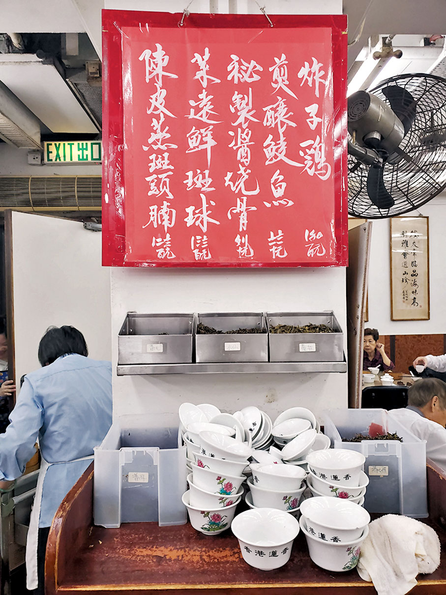 ◆蓮香樓手寫餐牌的價目仍用傳統花碼寫法。下方為顏氏第三代傳人設計的茶盅。 資料圖片