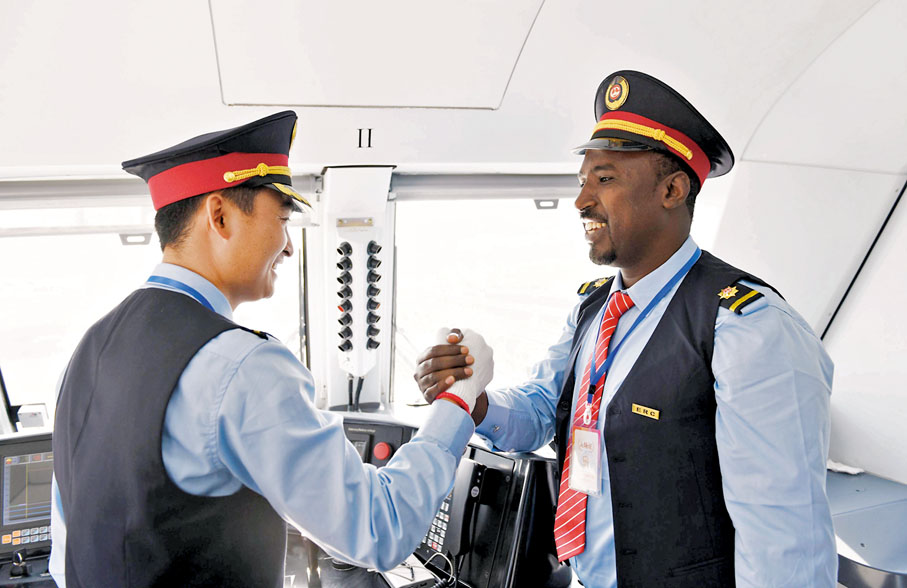 ◆「一帶一路」倡議密切了中國與沿線地區的人員交往。圖為中埃司機握手慶祝中企承建的埃塞俄比亞至吉布提鐵路通車。資料圖片